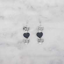 Load image into Gallery viewer, White With Black Heart Triple Small Heart Shaped Music Notes Dangle Earrings
